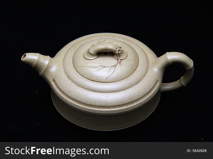 An teapot isolated on black background.