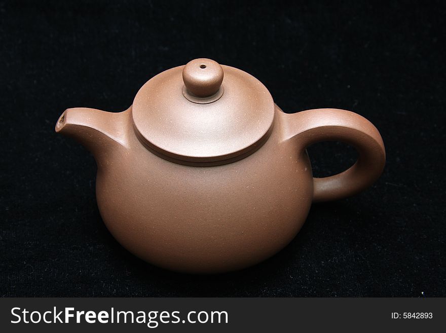 An teapot isolated on black background from China.