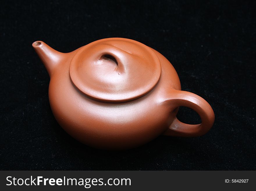 An teapot isolated on black.