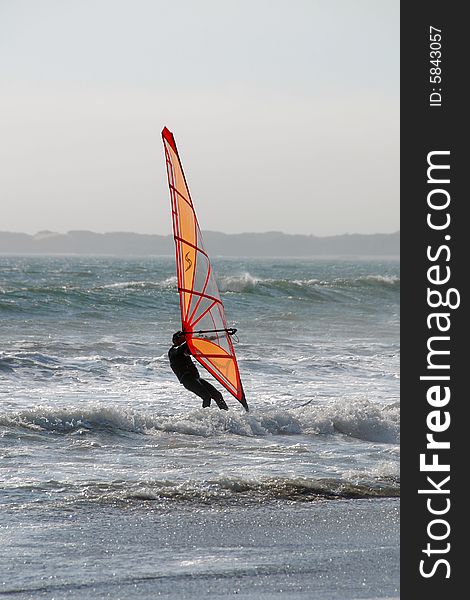 A windsurfer battling the wind and waves in nothern california. A windsurfer battling the wind and waves in nothern california