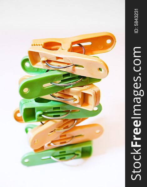 Several clothes pegs on white background