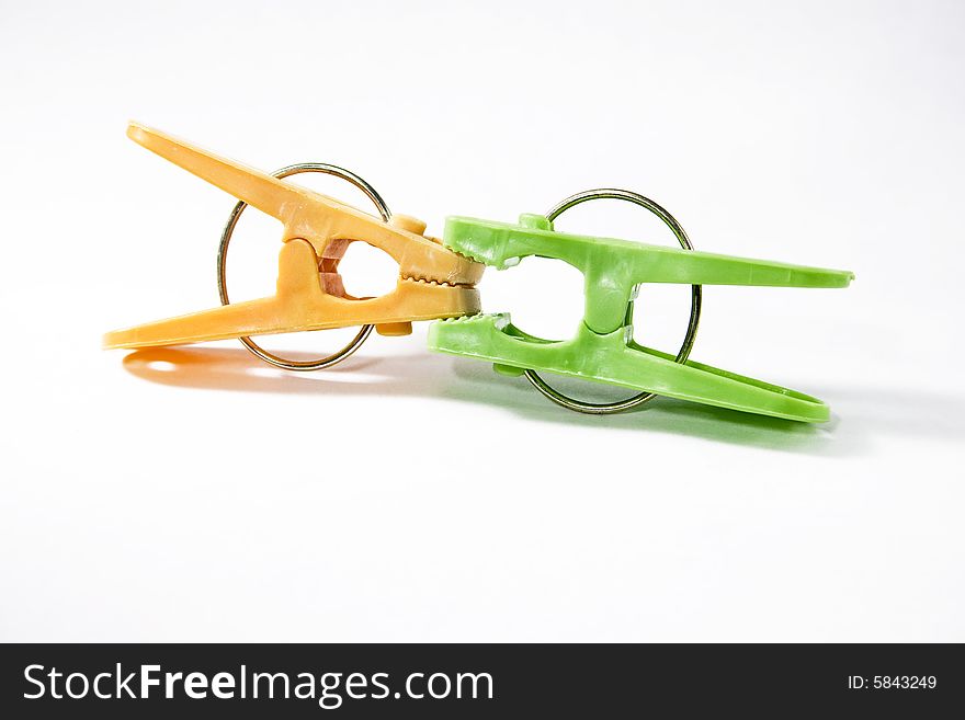 Two clothes pegs (orange and green)