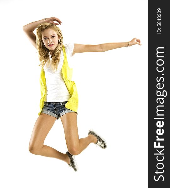 A beautiful blond Caucasian young girl (15-24) jumping with joy on white background. A beautiful blond Caucasian young girl (15-24) jumping with joy on white background