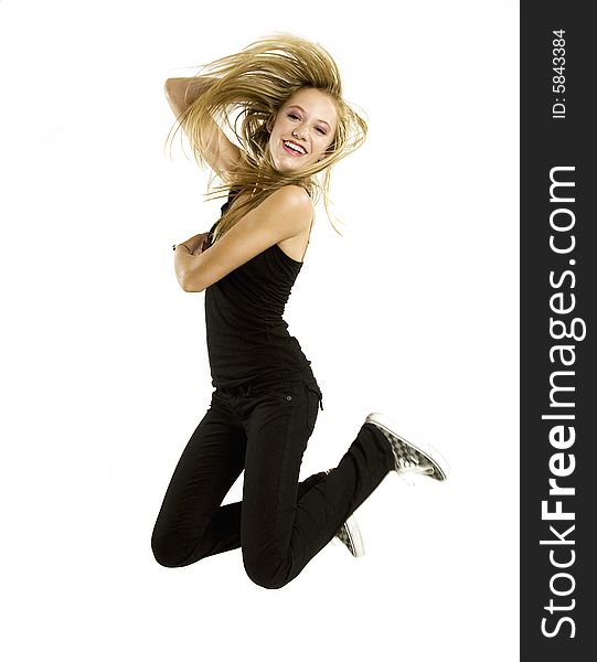 A beautiful blond Caucasian young girl (15-24) in black jumping with joy on white background. A beautiful blond Caucasian young girl (15-24) in black jumping with joy on white background