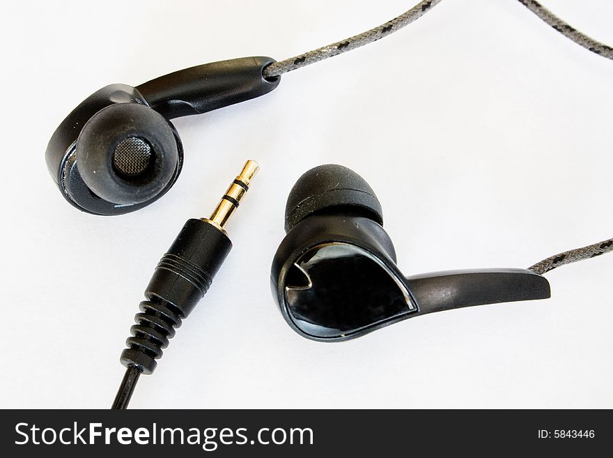 Headphones and cable on white background