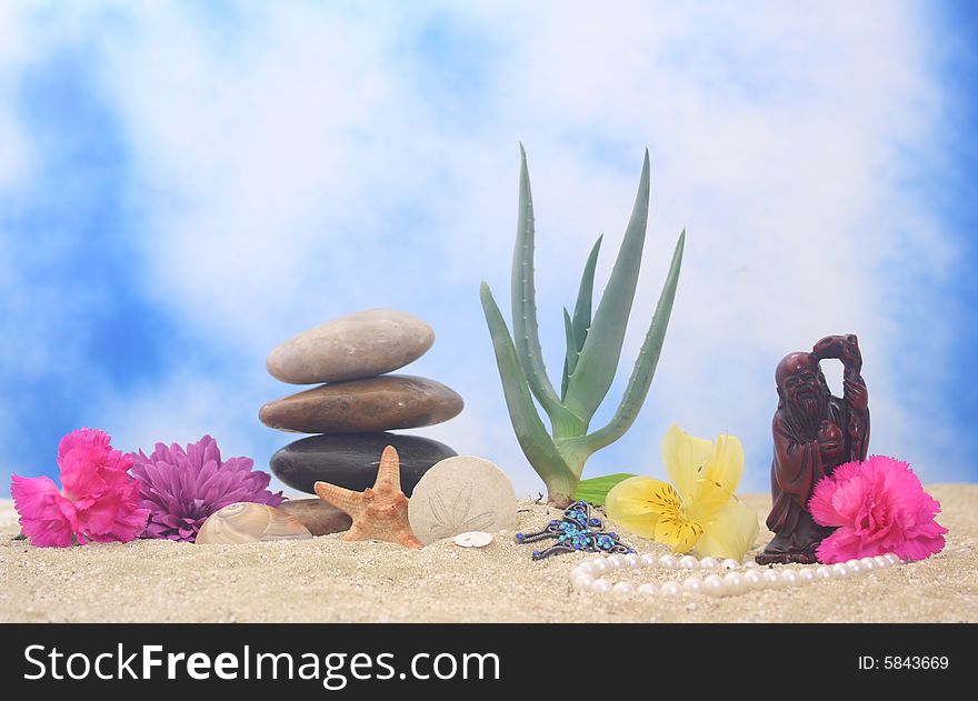 Aloe Vera and Buddha on Sand With Blue Background. Aloe Vera and Buddha on Sand With Blue Background