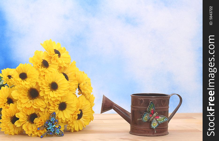 Yellow Flowers and Metal Water Can on Blue Textured Background. Yellow Flowers and Metal Water Can on Blue Textured Background