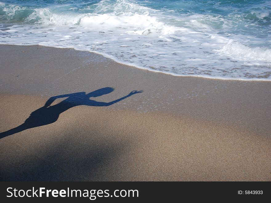 Womanish shade is on a beach