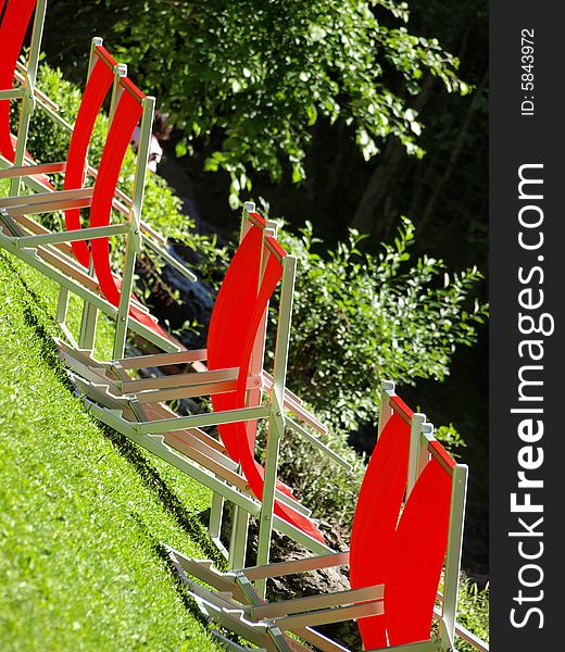 Some red deck chairs in a mountain park