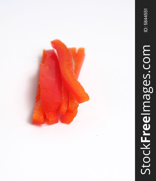 Sliced red pepper in sticks, on white background