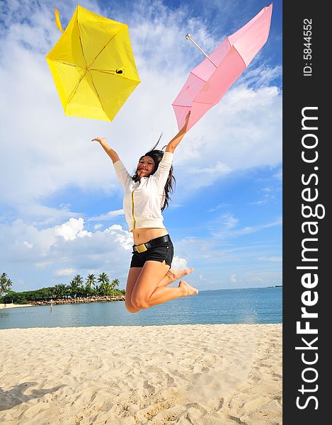 Jumping Girl on the beach with umbrellas. Jumping Girl on the beach with umbrellas.