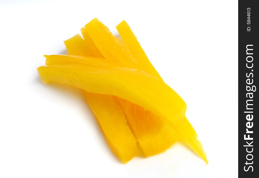 Sliced yellow pepper in sticks, on white background