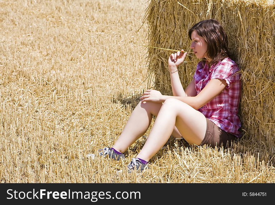 Young woman in haystack