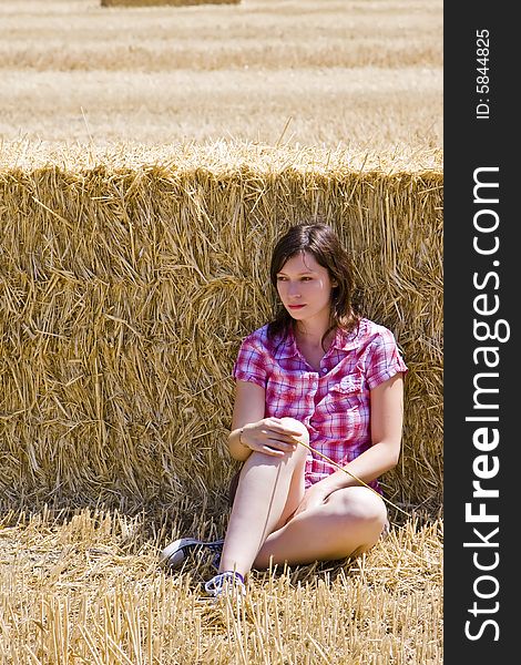 Young farmer resting on the haystack. Young farmer resting on the haystack