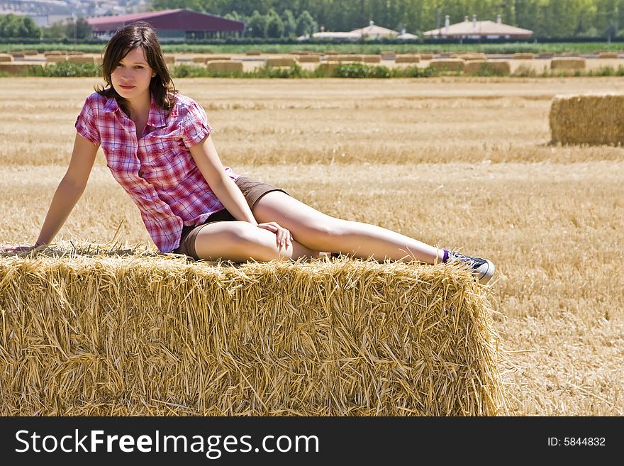 Young woman in haystack