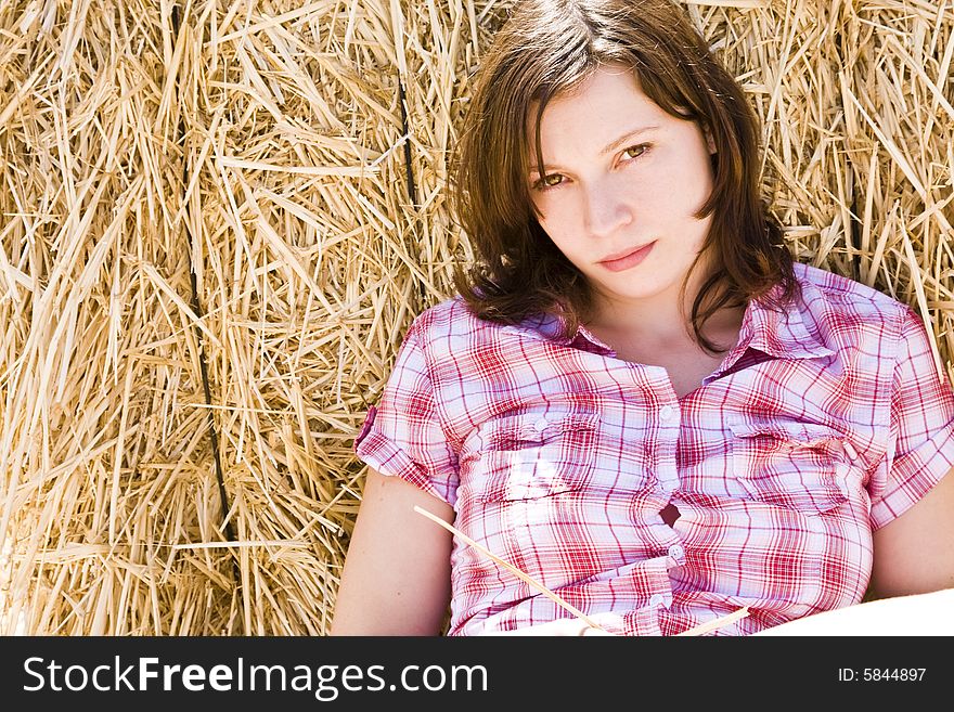 Young woman in haystack