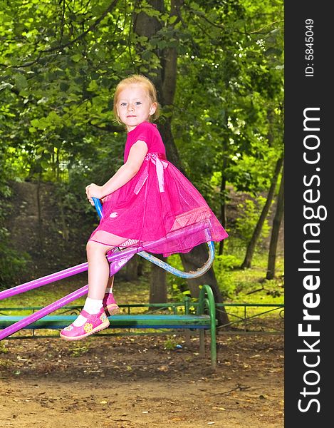 Cute 3-year-old girl on swing in the park. Cute 3-year-old girl on swing in the park