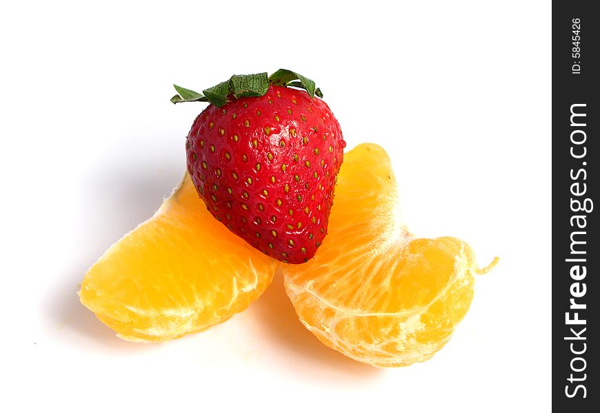 Organic Tangerine segments and a strawberry, on white background