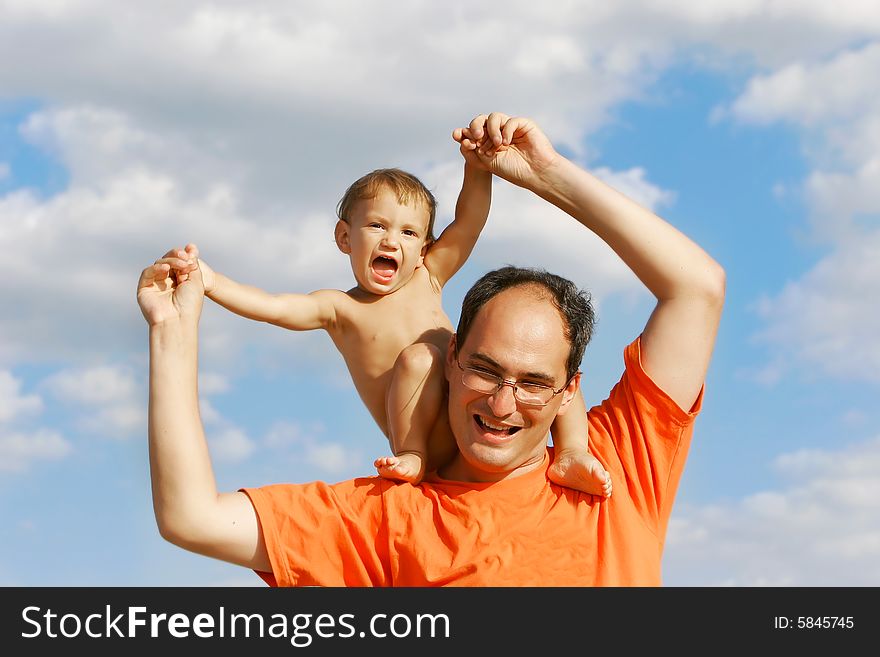 Father and son on sky background