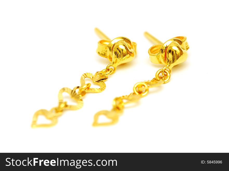 A pair of golden earrings isolated on white background.