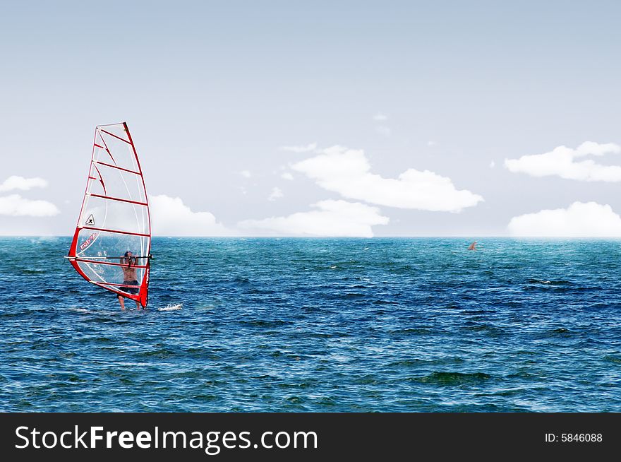 Image of a wind surfer on the waves of the sea. Image of a wind surfer on the waves of the sea