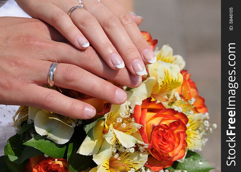 Newly-weds holding a wedding bouquet