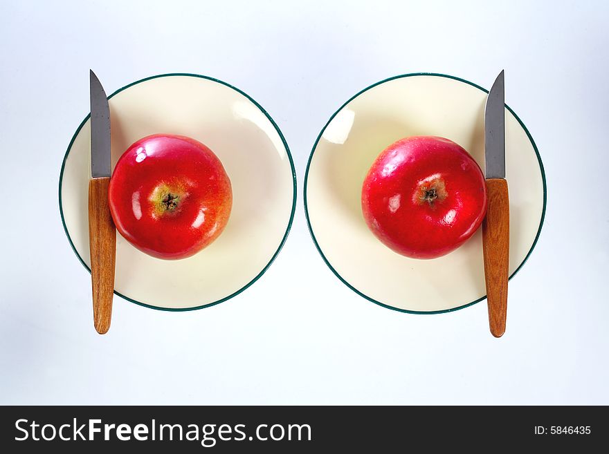 Two apples on dessert plates. Two apples on dessert plates