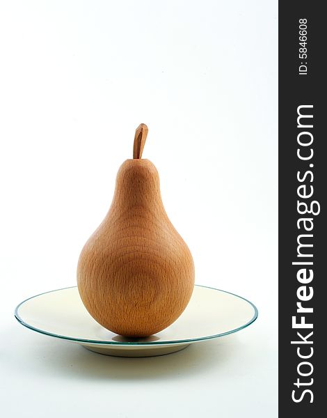 Wooden pear on a plate