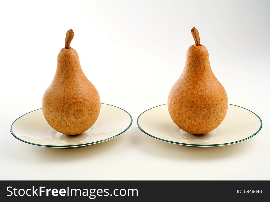 Two wooden pears on a plate