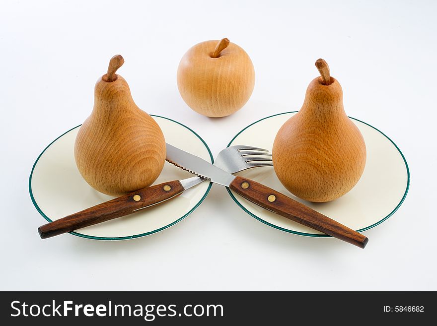 Wooden pears with an apple and setting. Wooden pears with an apple and setting