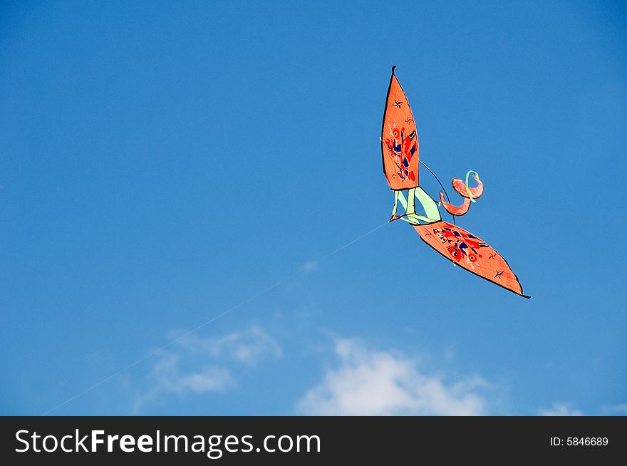 Image of a kite isolated against the blue sky. Image of a kite isolated against the blue sky