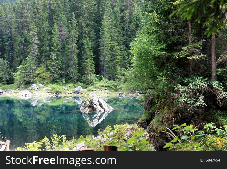 Sella montain group, green valley and woods. carezza lake water tourquoise colours. Italy. Sella montain group, green valley and woods. carezza lake water tourquoise colours. Italy