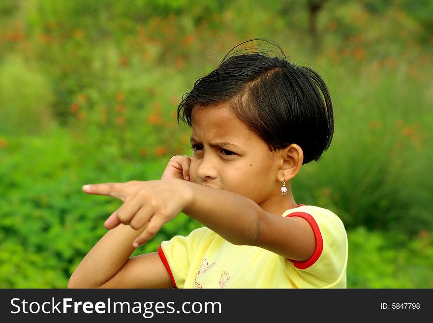 A girl showing something by pointing the finger. A girl showing something by pointing the finger.