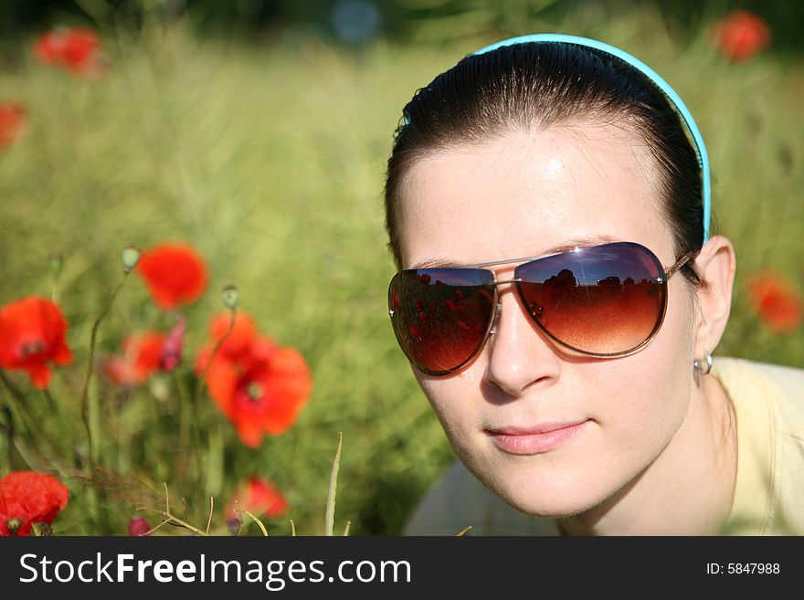 Smiling woman in poppy field