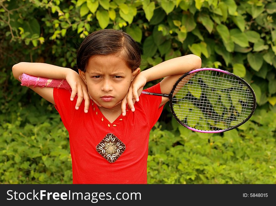 A child with badminton racket. A child with badminton racket.