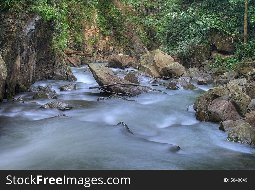 On a photo mountain river stone with moss. Ukraine