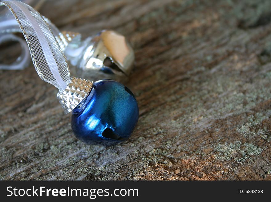 Blue and Silver Christmas bells attached to a ribbon on a wood background. Room for copy space. Blue and Silver Christmas bells attached to a ribbon on a wood background. Room for copy space.
