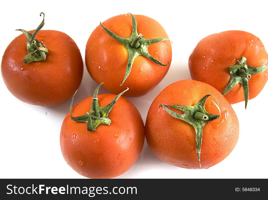 Five tomatoes on white background