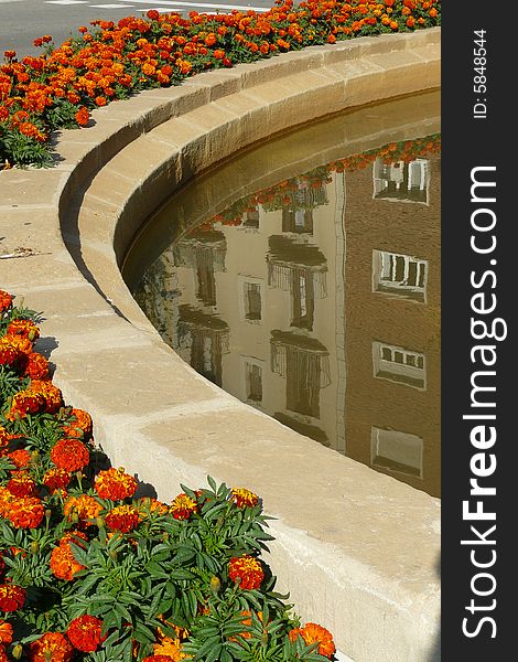 The houses are reflected on the fountain in Barcelona. The houses are reflected on the fountain in Barcelona