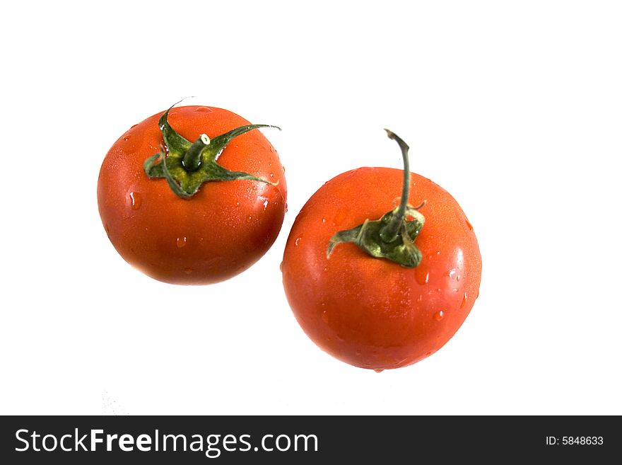 Two tomatoes on white background