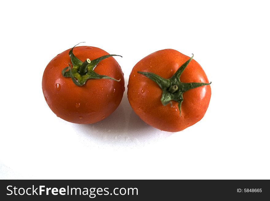 Two tomatoes on white background