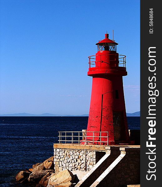 A lanscape with blue sea and red lighthouse. A lanscape with blue sea and red lighthouse