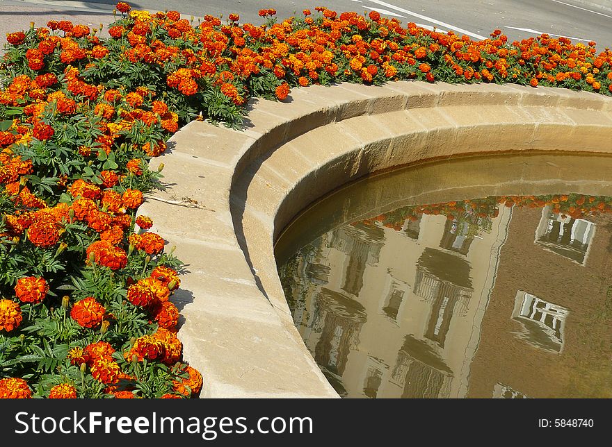 The houses are reflected on the fountain in Barcelona. The houses are reflected on the fountain in Barcelona