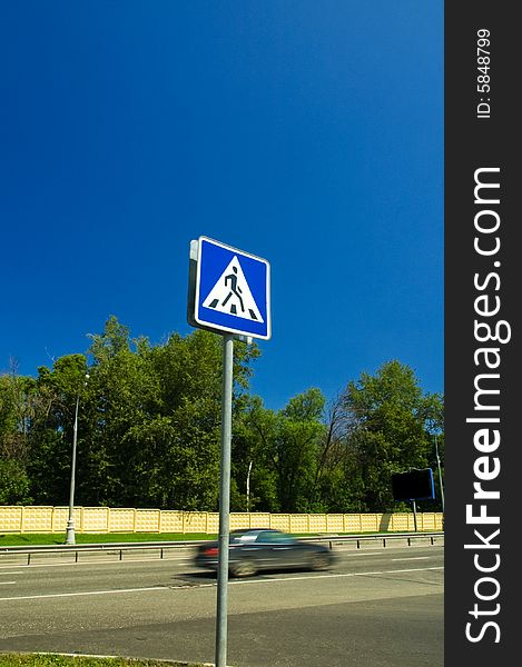 Pedestrian road sign passed by a car