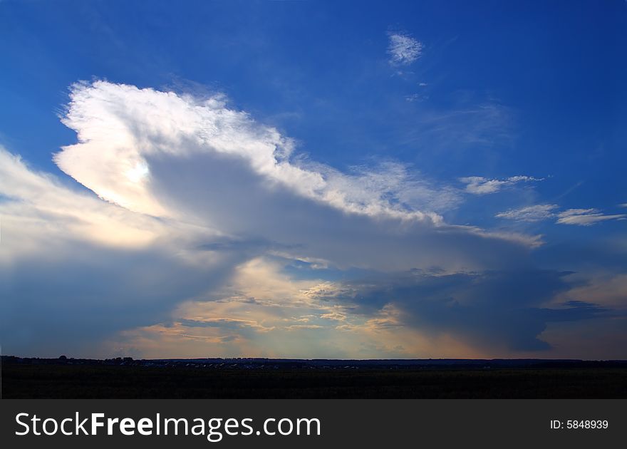 Raining clouds in blue sky on horizon. Raining clouds in blue sky on horizon