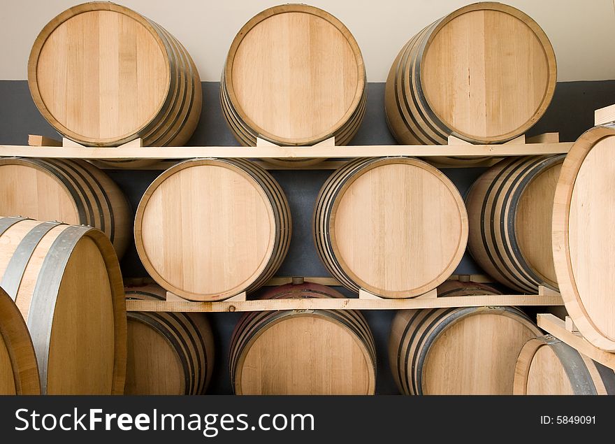 A row of wine barrel full of wine. A row of wine barrel full of wine