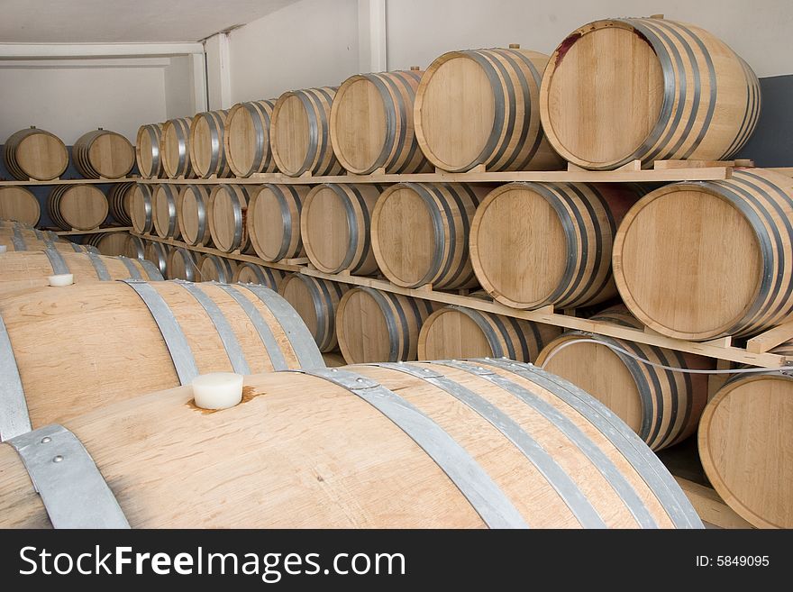 A row of wine barrel full of wine. A row of wine barrel full of wine