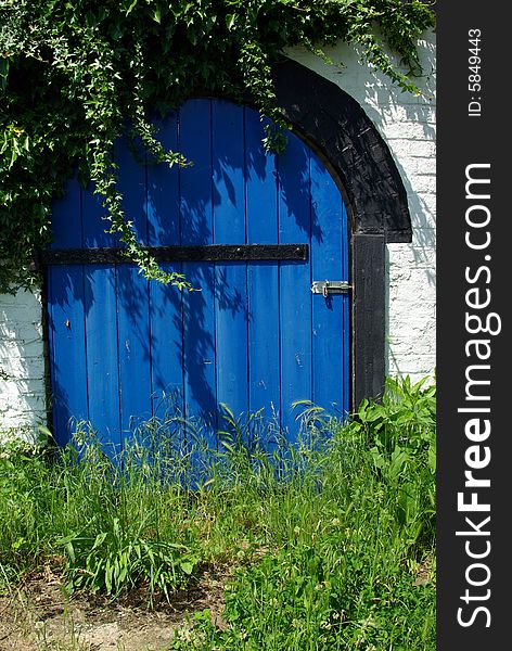 Detail view of a blue old door made of wood.