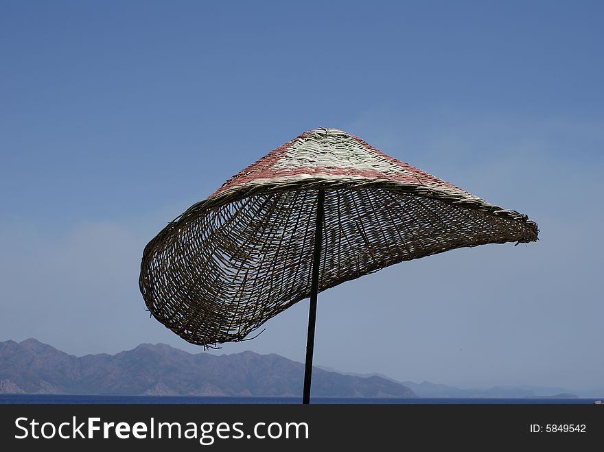 Beach umbrella in front of sea. Beach umbrella in front of sea