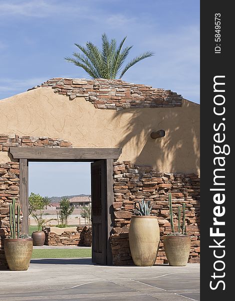 Beautiful old stone entrance with potted cactus vegetation. Beautiful old stone entrance with potted cactus vegetation